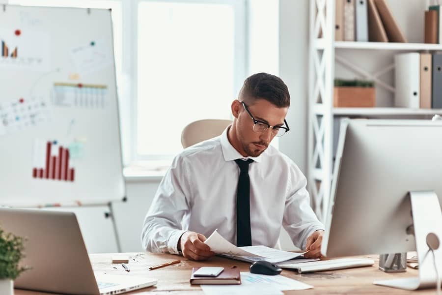 businessman seriously working on his office