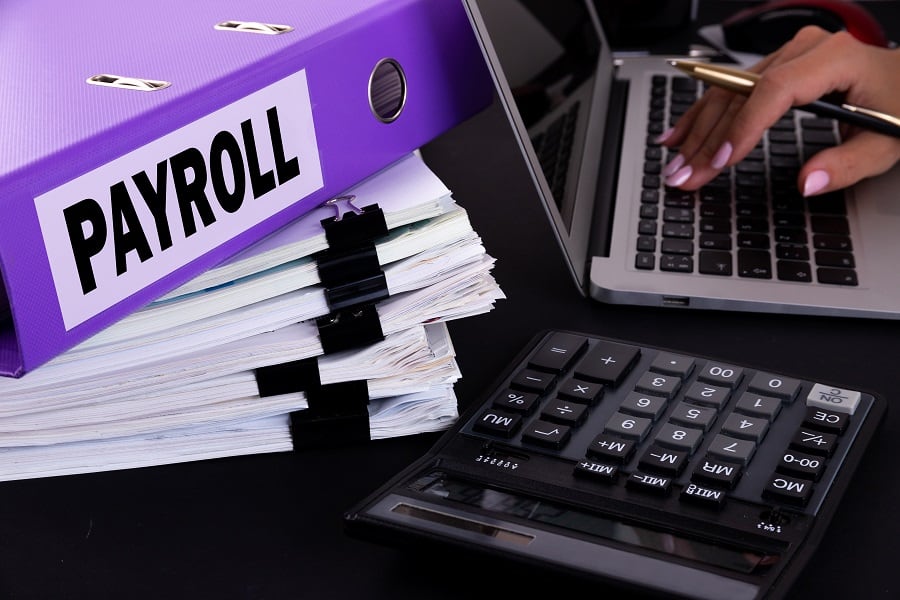 file of paper and payroll log book