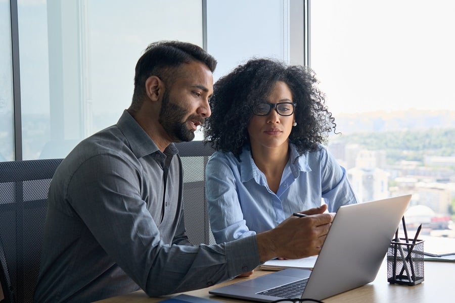 two employees have a serious discussion inside the office