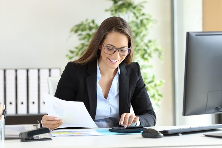 beautiful employee working in her office holding documents